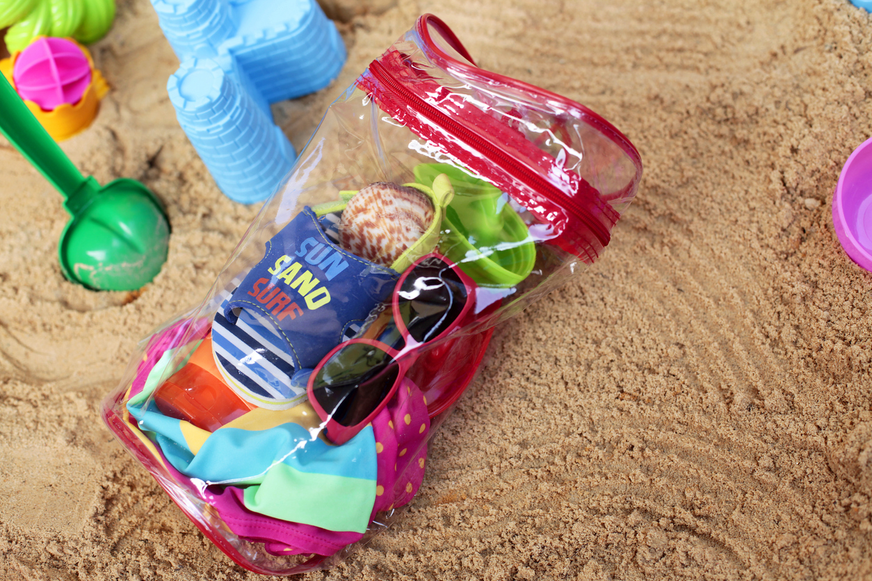 Transparent beach bag with necessary things for beach fun